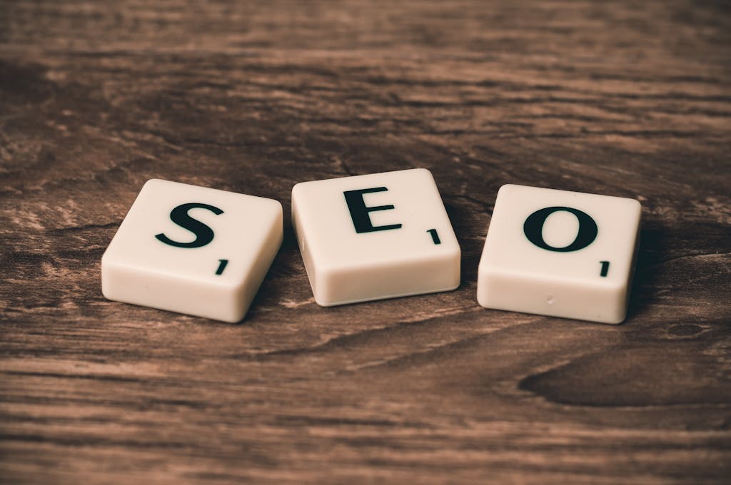 7 Google Business Profile Mistakes That Are Killing Your Local Reach (And How to Fix Them) 2 Scrabble tiles spelling 'SEO' on a wooden surface. Ideal for digital marketing themes.